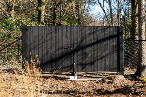Wooden swing gate with a black finish