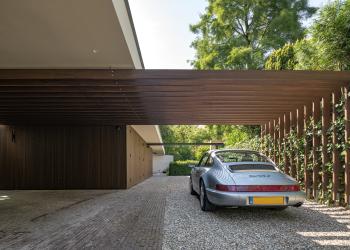 Timber cladding and tailored beams for a carport