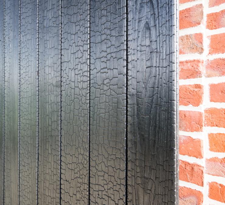 Charred timber cladding is a lovely contrast with the red brick