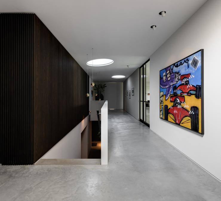 Black oak wall panelling contrasting with clean white walls