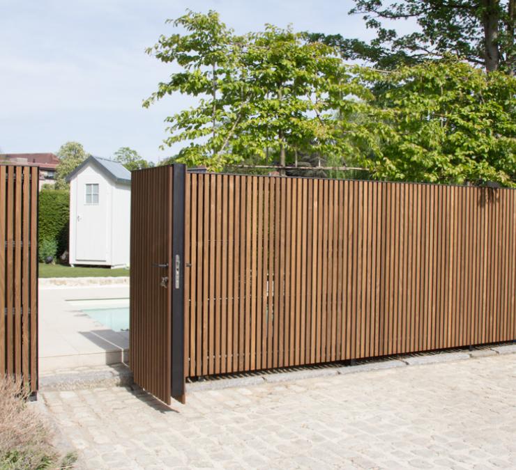Portillon et clôture revêtu en frêne HOTwood profil Fine line QC Portillon avec cadre en aluminium intégré dans la clôture en bois revêtu du profil Fine line QC en frêne HOTwood