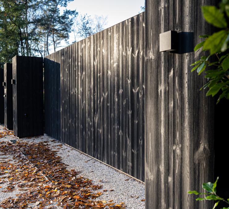 Wooden sliding gate with covered posts