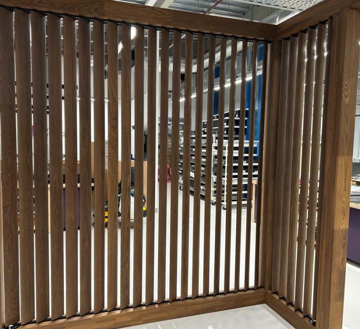 Room divider with elliptical HOTwood ash louvers