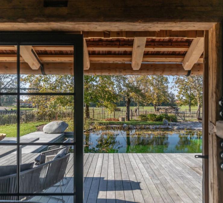 Weathered deck in Kebony surrounding a natural swimming pool