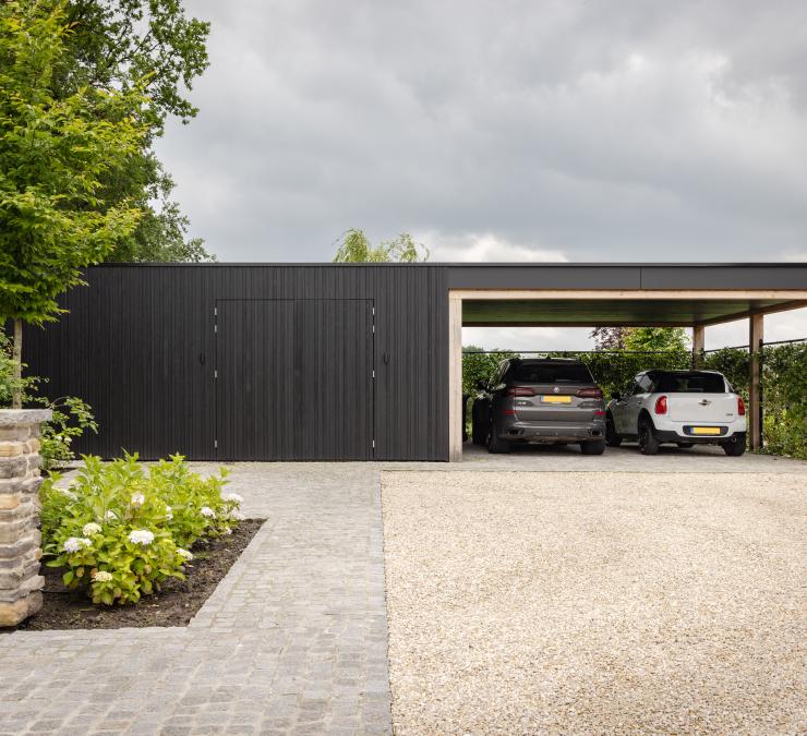 Modern carport with black wood garden building